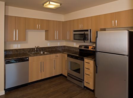 One-bedroom kitchen with granite counters and stainless steel appliances